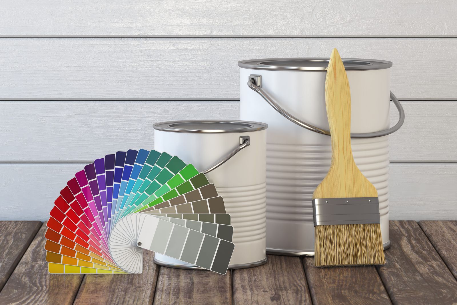 Paint colour fan deck, brushes and paint tins laid out while planning a house painting quote
