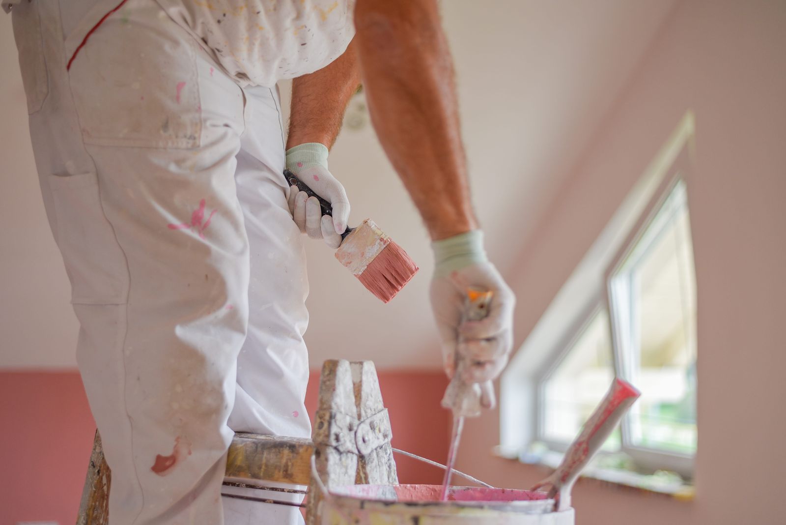 Residential painter applying fresh paint to a home interior